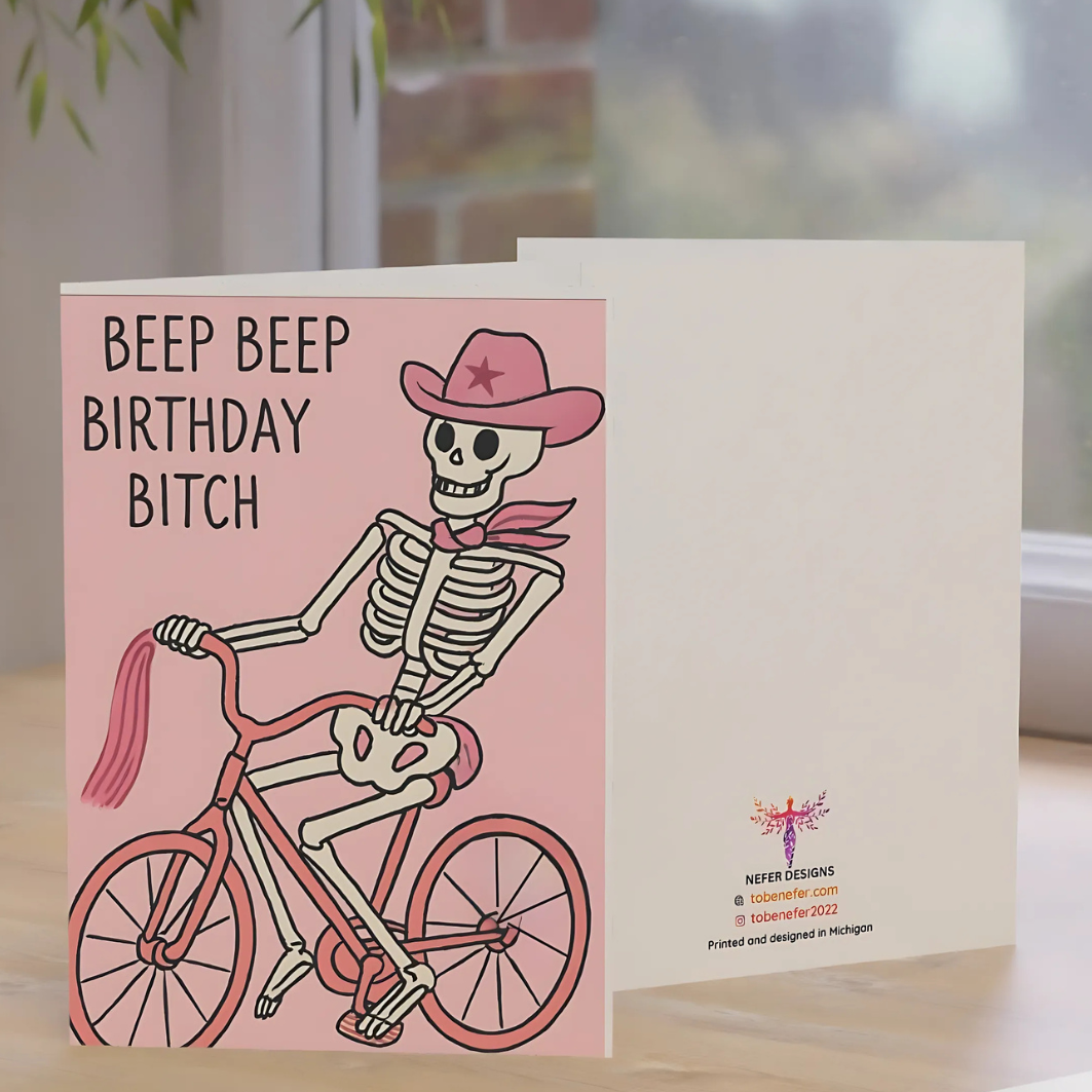 Card with skeleton on a bike and text 'Beep Beep Birthday Bitch' on a pink background