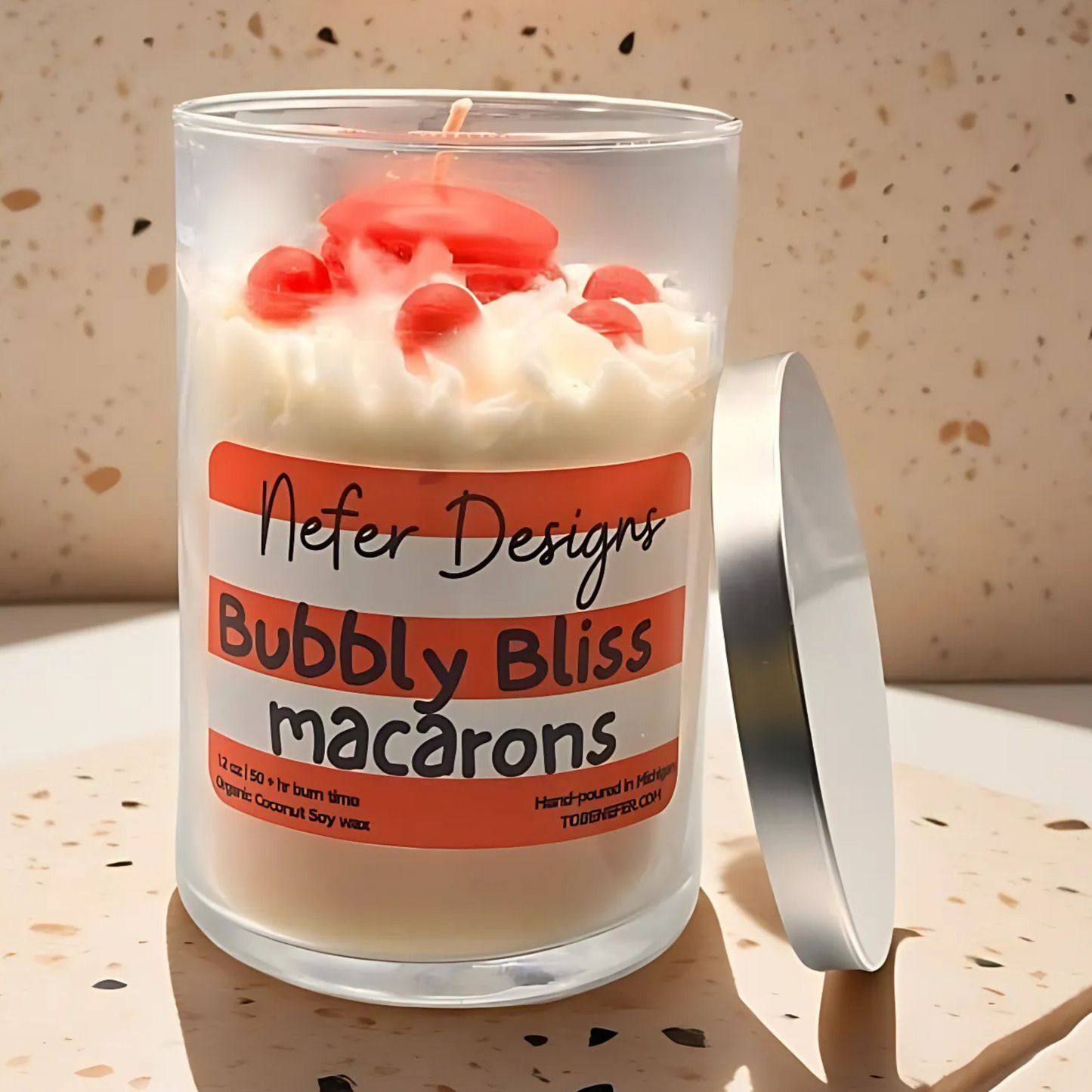 A luxurious champagne-scented candle in an elegant jar, surrounded by pastel macaron decorations, evoking a sense of celebration and indulgence.