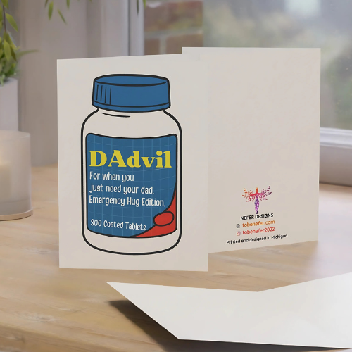 Card with a 'DAvil' pill bottle design on a wooden surface.