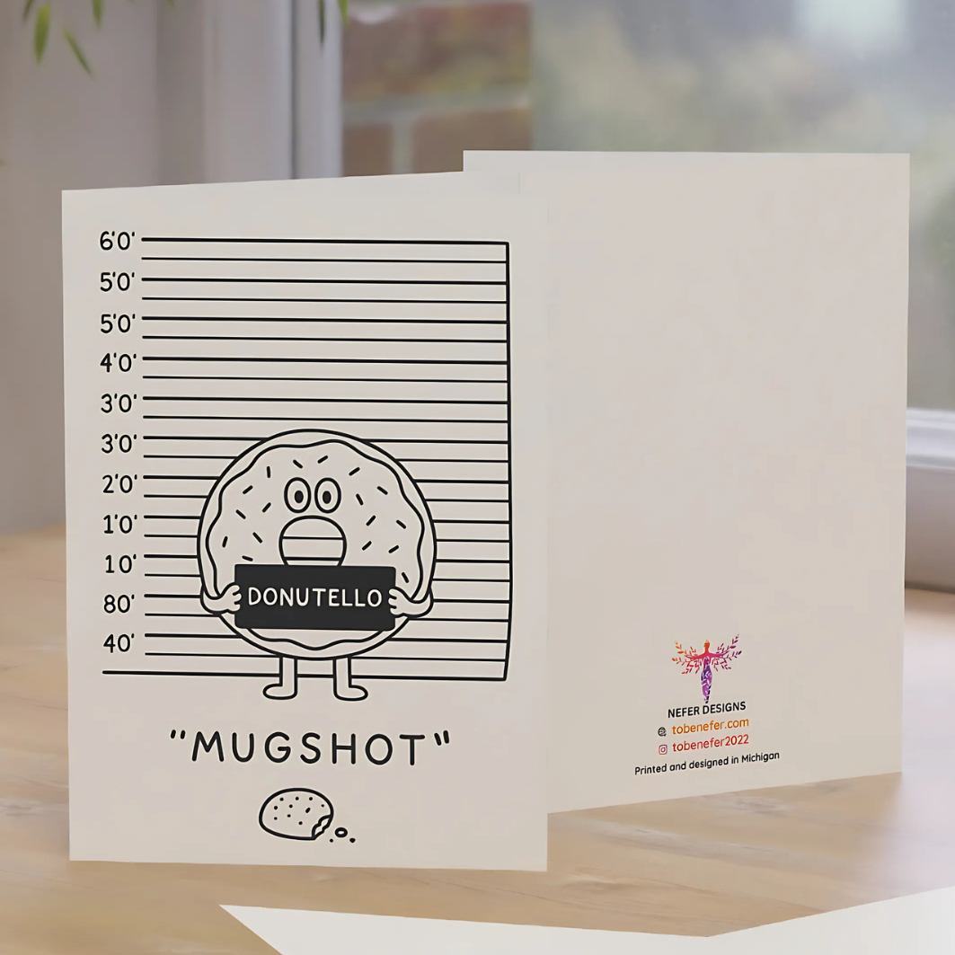 Greeting card with 'Mugshot' donut design on a wooden surface