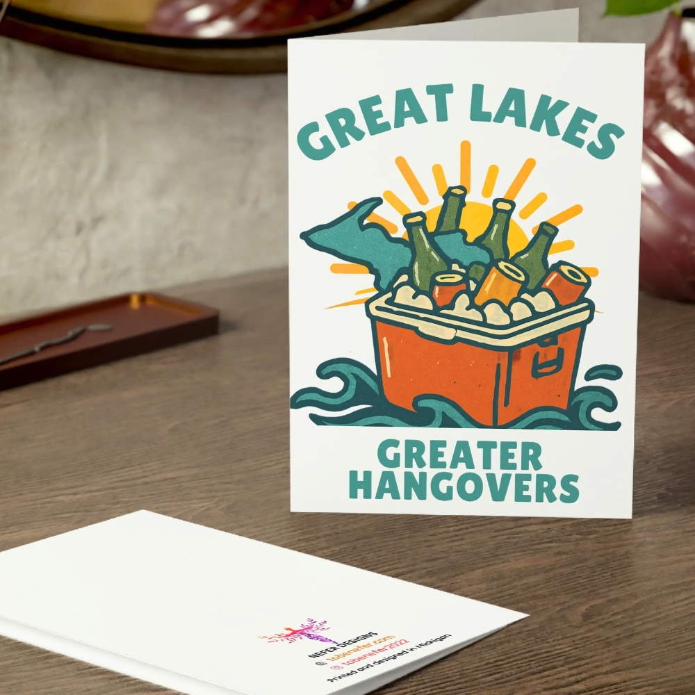 Greeting card with 'Great Lakes Greater Hangovers' design on a wooden surface