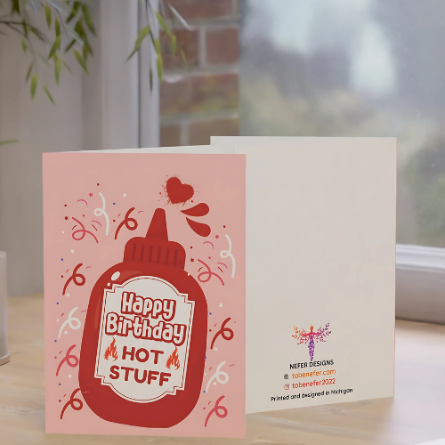 Birthday card with hot sauce design on a table