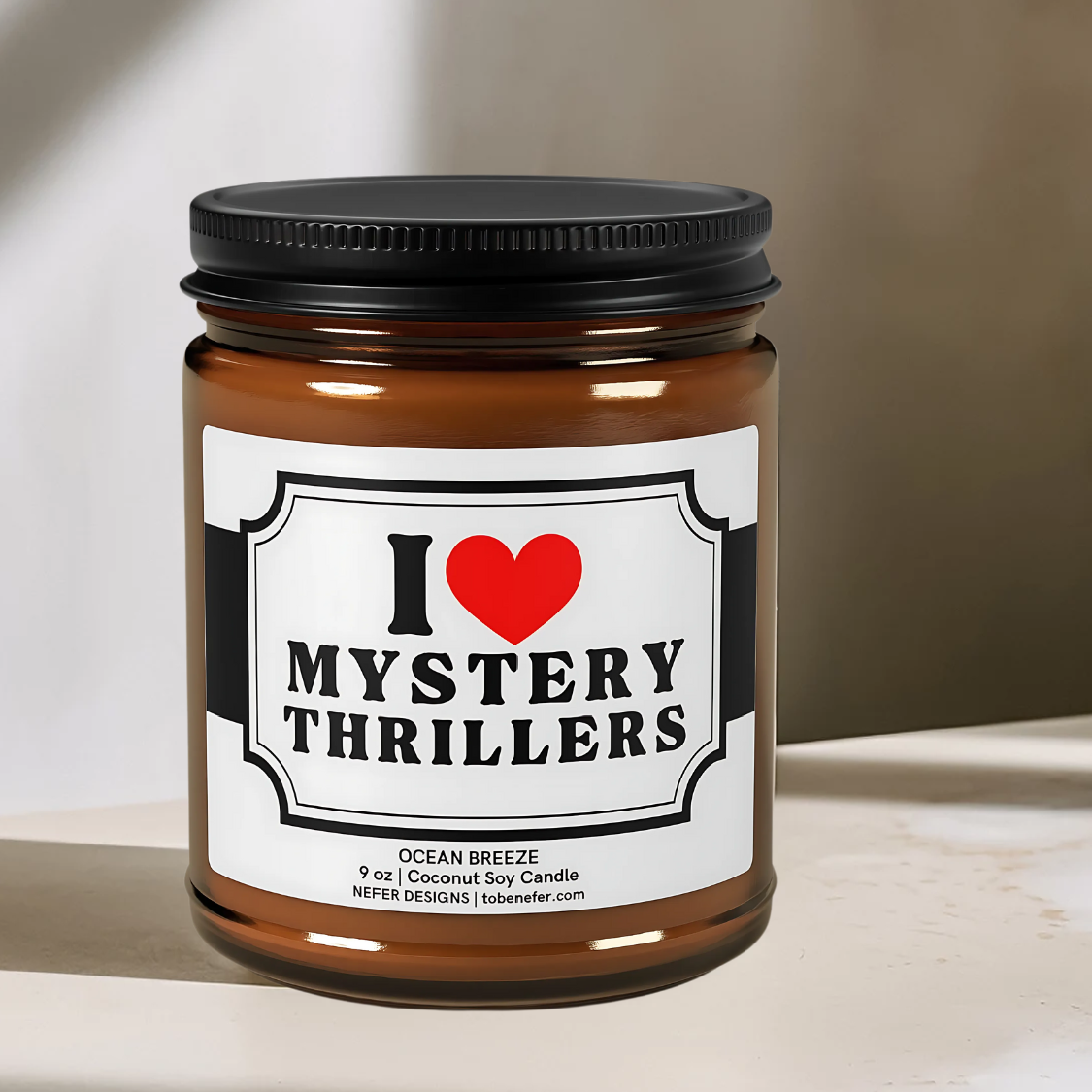 "I Love Mystery Thrillers scented candle in amber jar with a black lid.