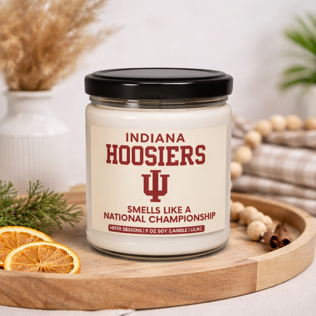 Candle jar with 'Indiana Hoosiers' design on a wooden tray with decorative elements.