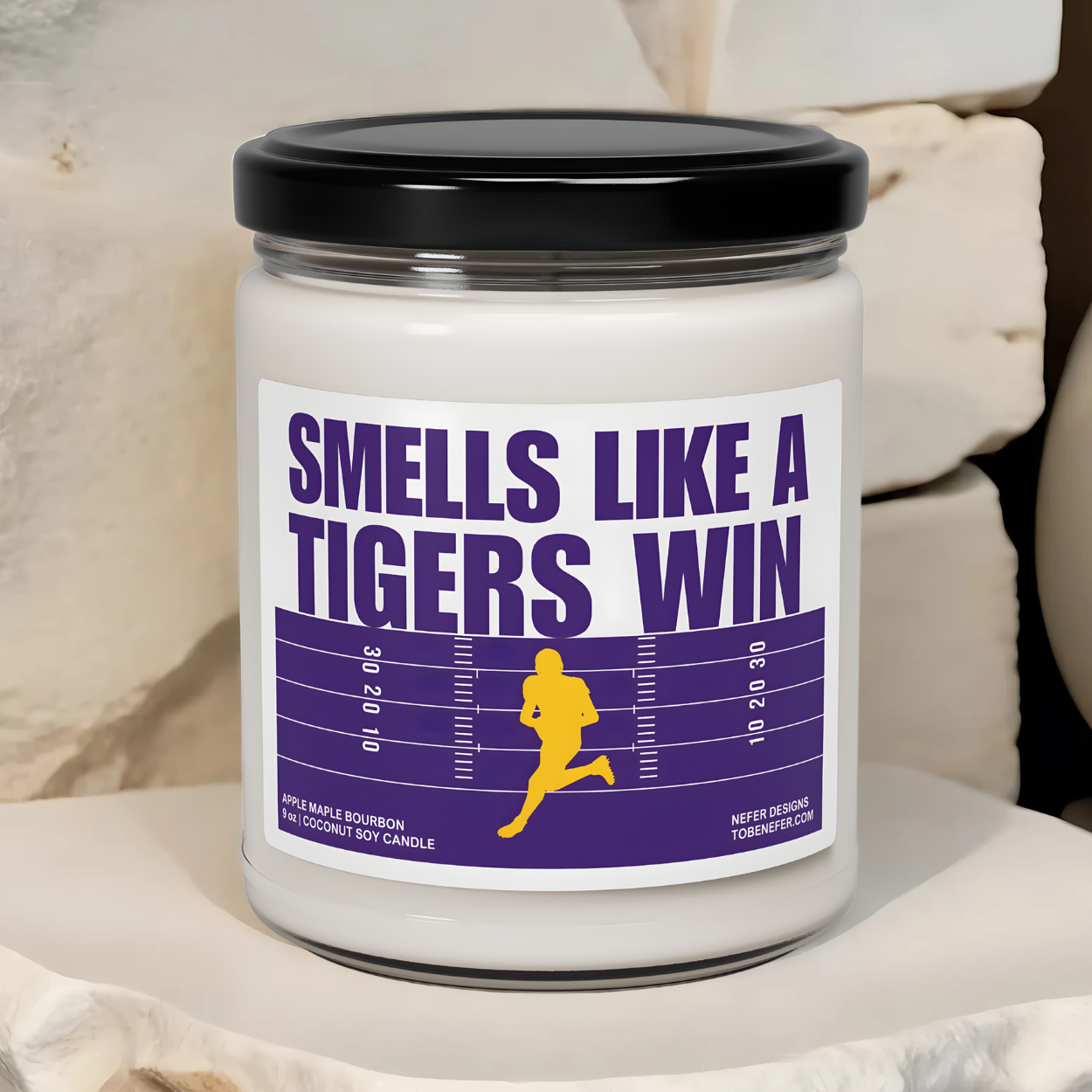 Louisiana tigers game day candle with the purple and yellow team colors on the label saying smells like a tigers win