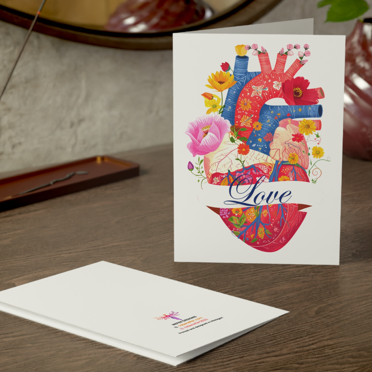 Greeting card with colorful heart design and 'Love' text on a wooden surface.
