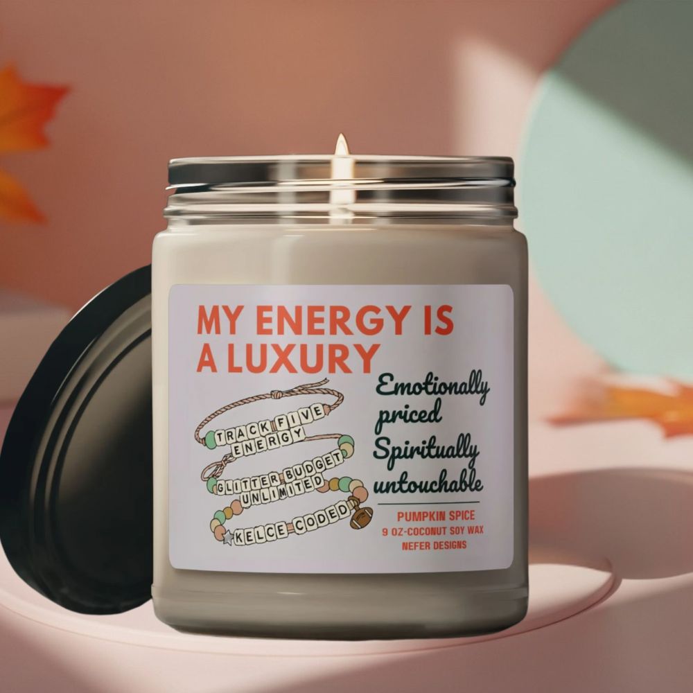 Candle jar with a label reading 'My Energy is a Luxury' on a soft background