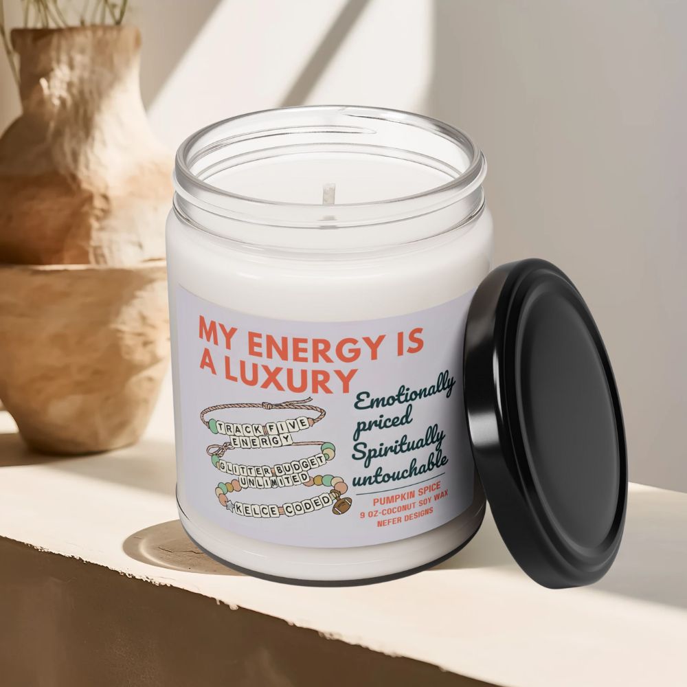 Candle in a glass jar with a label on a shelf