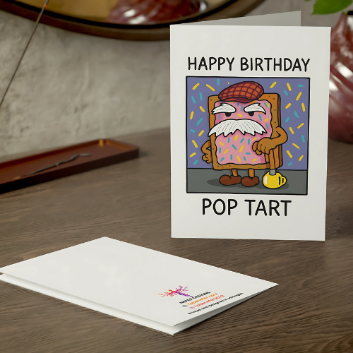 Birthday card with cartoon pop tart design on a wooden surface