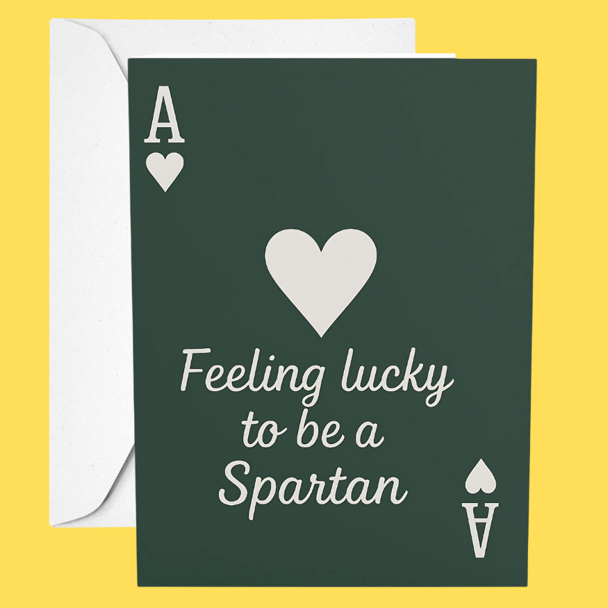 Card with 'Feeling lucky to be a Spartan' text and heart design on a yellow background