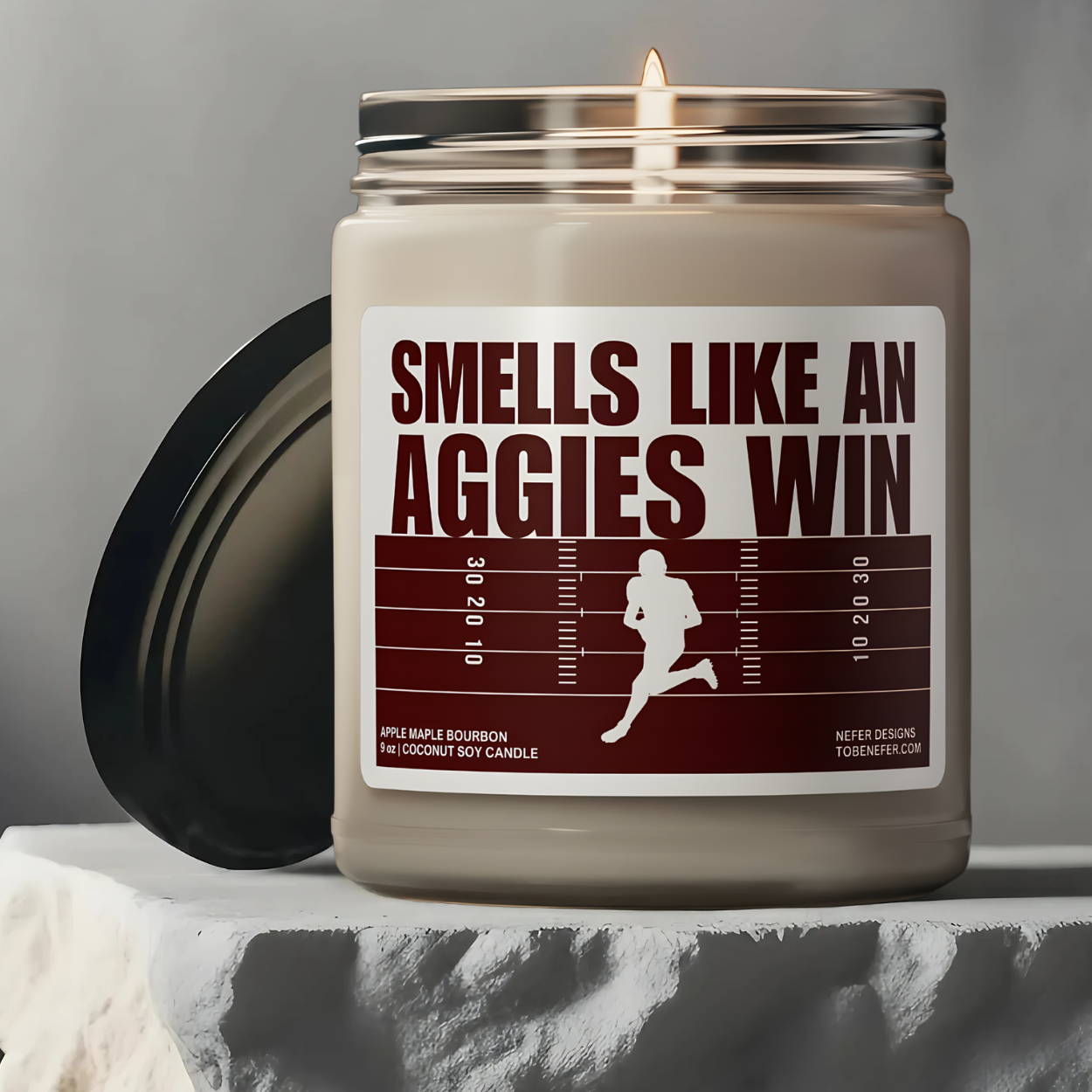 Texas Aggies football game day candle with the colors of the team on the label