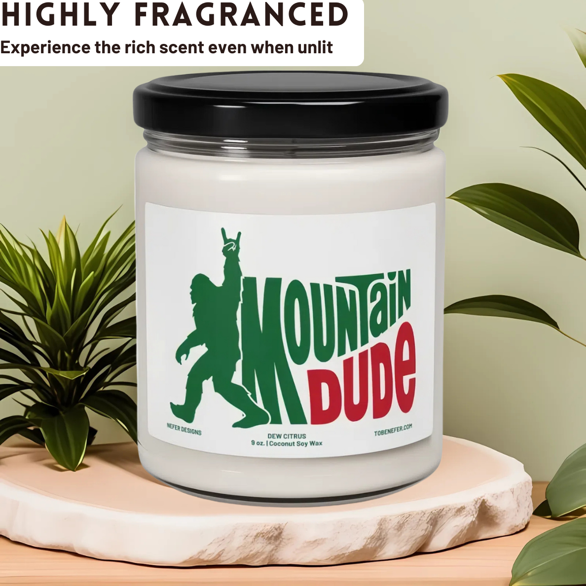 A 9 oz Mountain Dude Soda Pop Soy Candle in a jar, featuring a vibrant bigfoot design with the wording of mountain dude. The candle is hand-poured with a coconut and soy wax blend, offering a refreshing lemon-lime soda scent. Perfect for soda lovers and nostalgia enthusiasts.