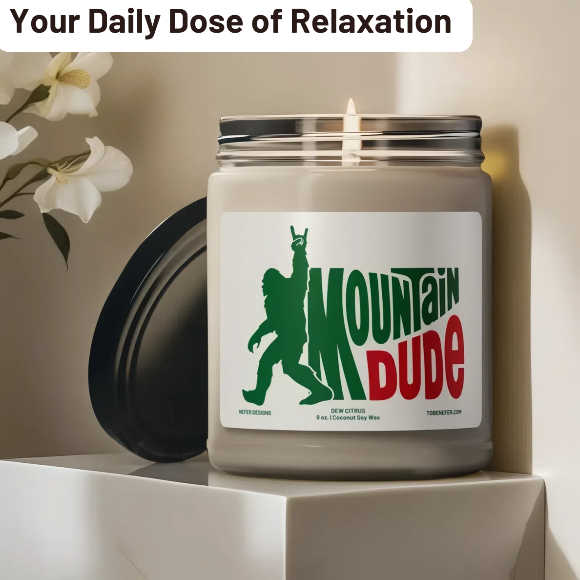 A 9 oz Mountain Dude Soda Pop Soy Candle in a jar, featuring a vibrant bigfoot design with the wording of mountain dude. The candle is hand-poured with a coconut and soy wax blend, offering a refreshing lemon-lime soda scent. Perfect for soda lovers and nostalgia enthusiasts.
