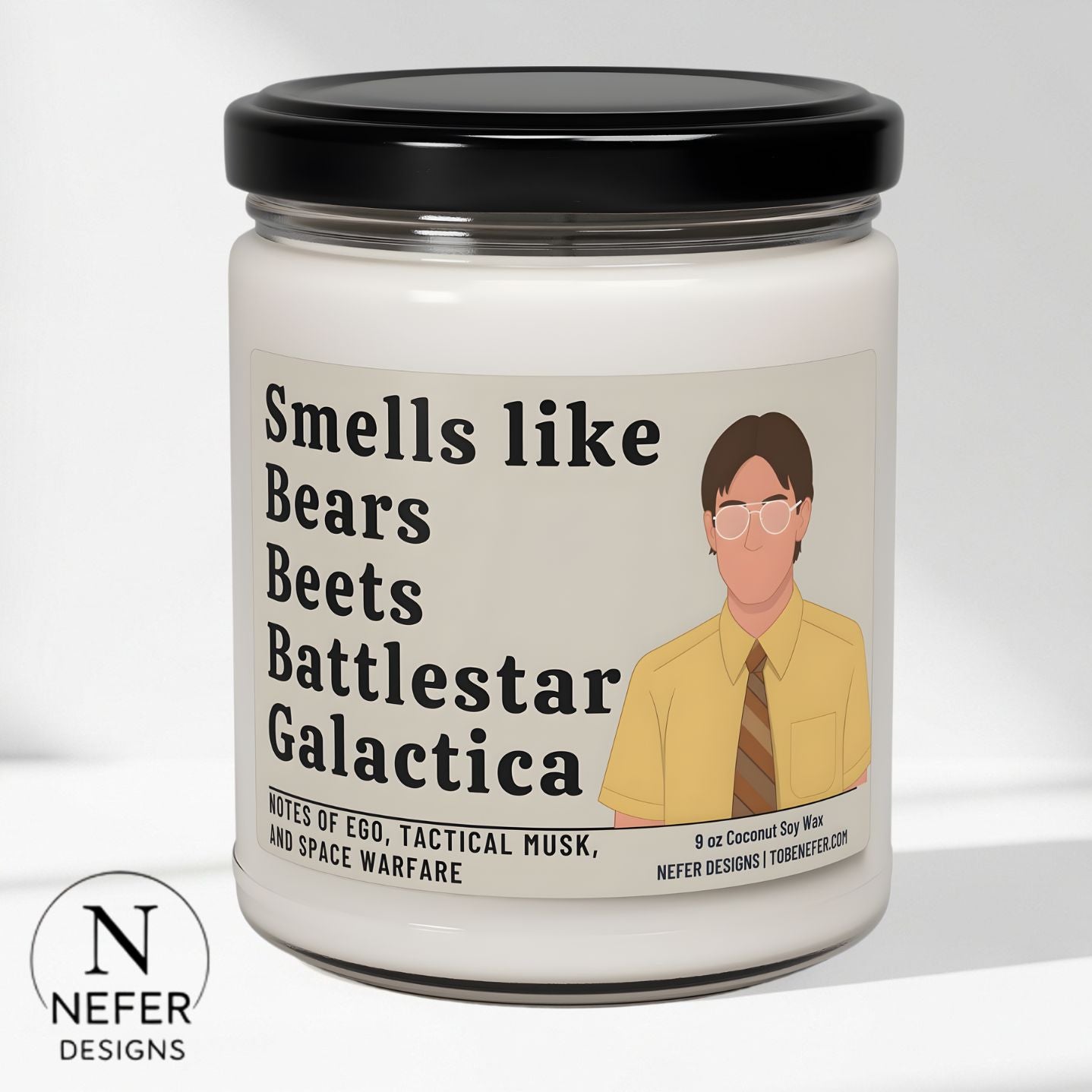 Candle jar with a label featuring text and an illustration of a Dwight from the Office sitcom show on a white background.