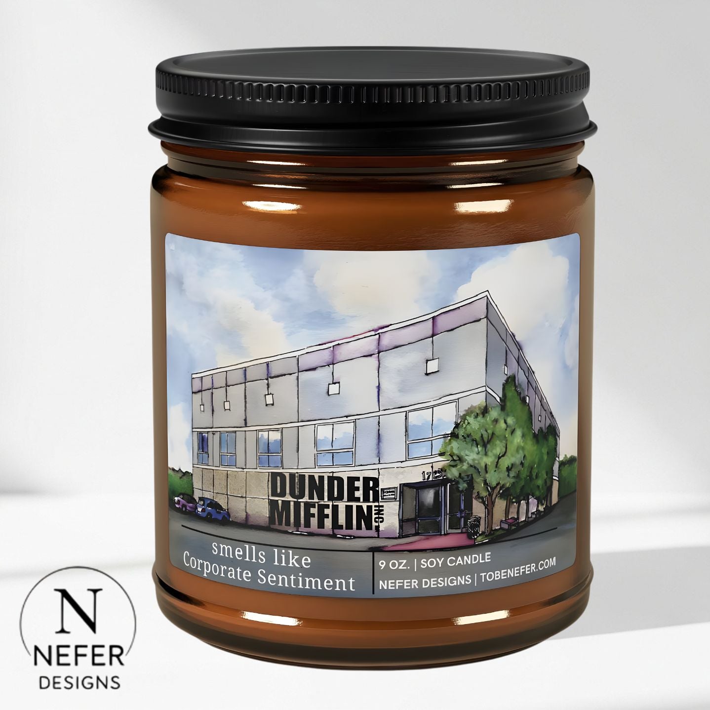 Candle jar with a label featuring 'Dunder Mifflin' building and Nefer Designs logo.