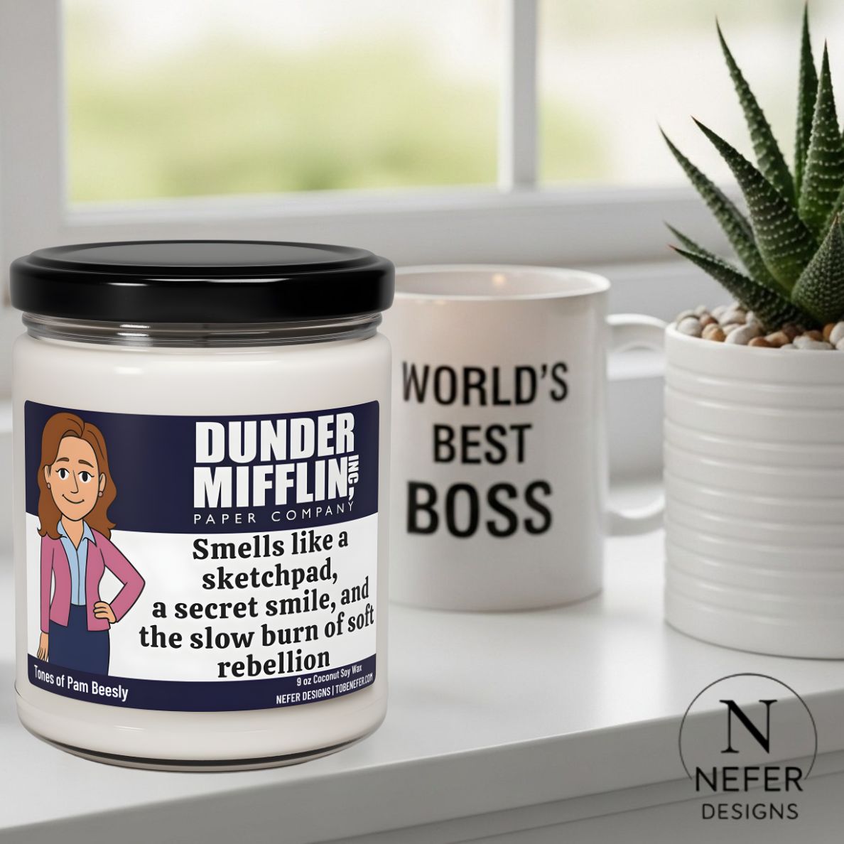 Scented Candle with Dunder Mifflin label and 'World's Best Boss' mug on a surface.