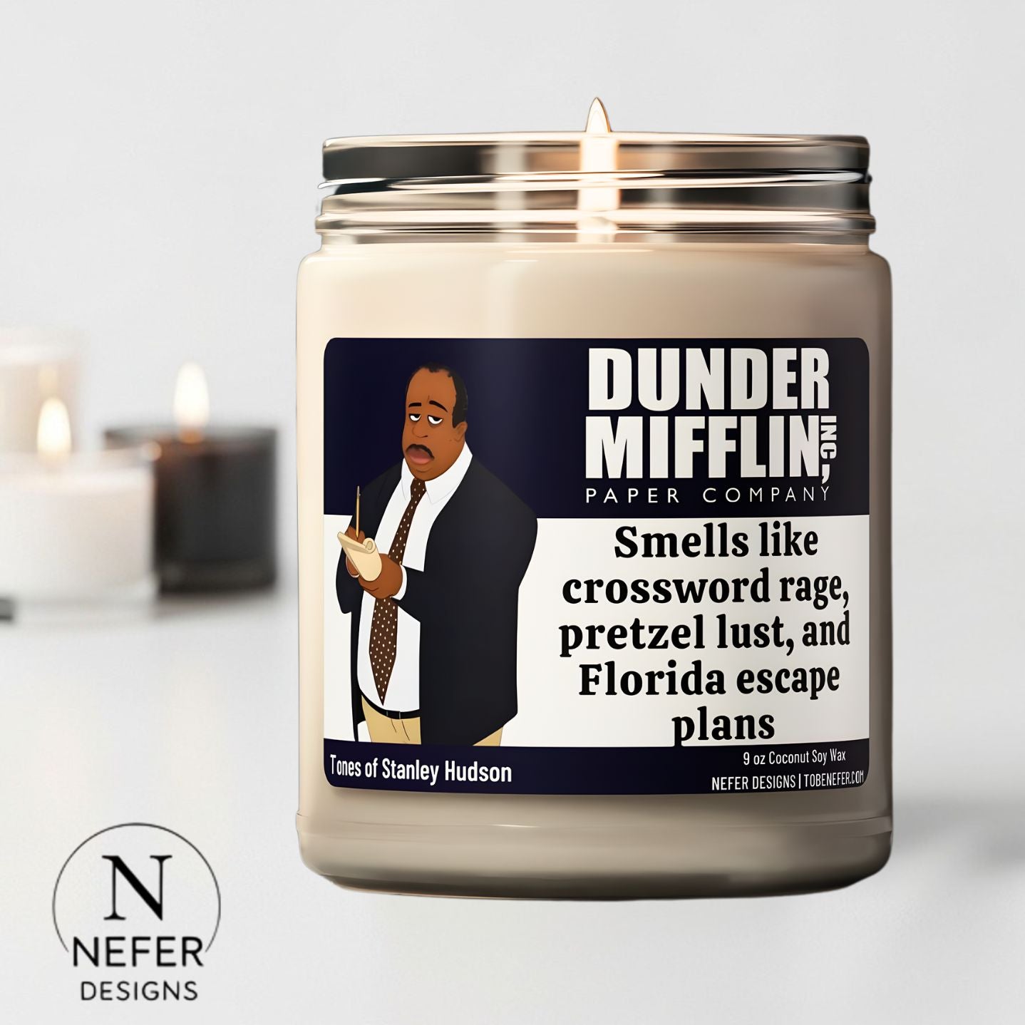 Candle with a label featuring a character from 'The Office' and the brand 'Nefer Designs'.