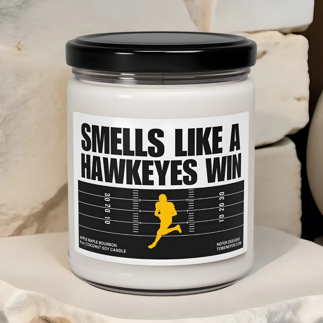 Smells Like a Hawkeyes Win game day candle with the label showing the school colors.