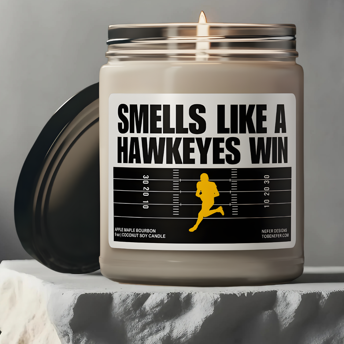 Smells Like a Hawkeyes Win game day candle with the label showing the school colors.