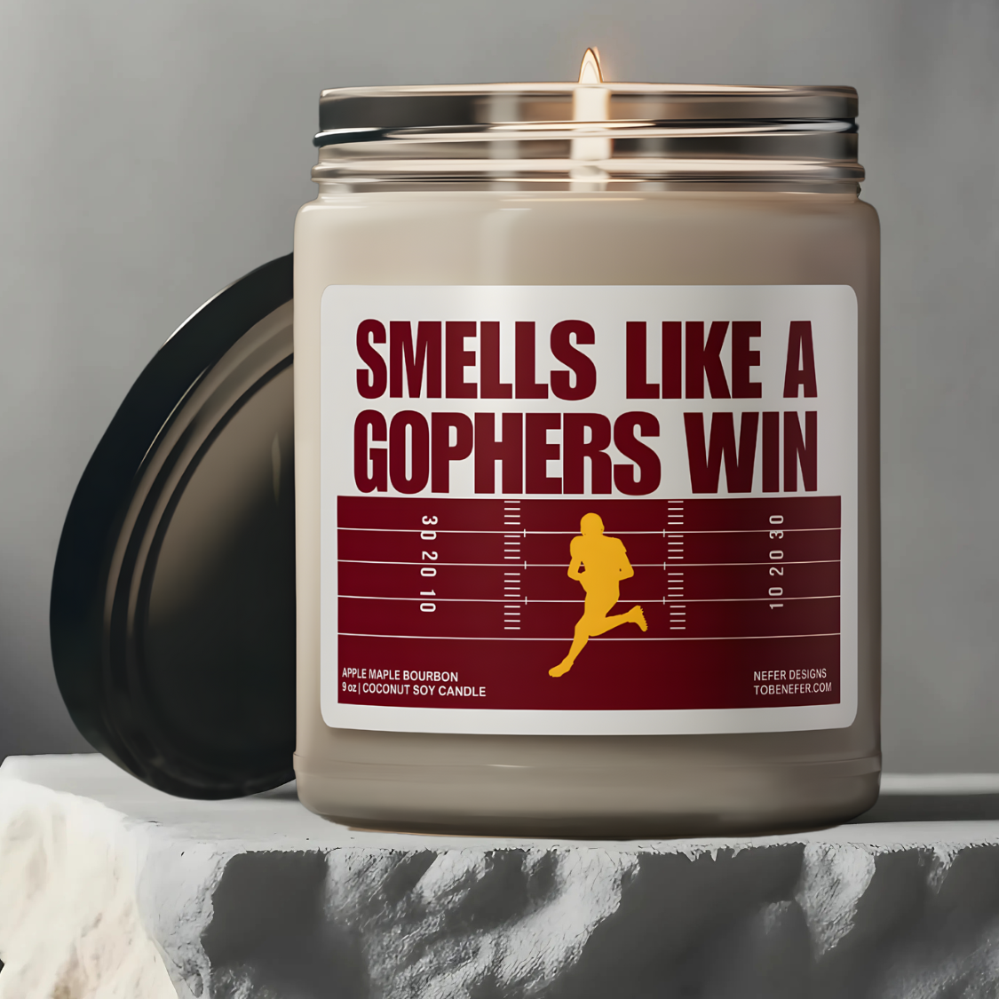 Gophers game day candle with the themed colors on the label