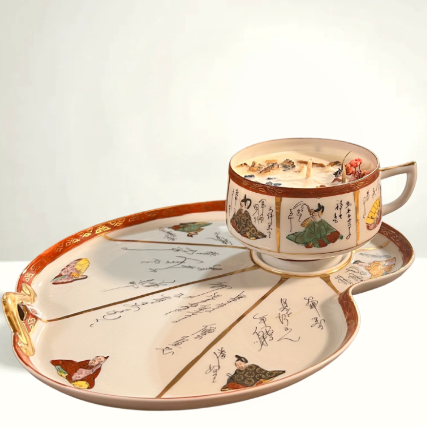 Exquisite hand-painted teacup and saucer featuring traditional Japanese figures, cranes, and peonies—symbols of longevity and prosperity. A striking example of mid-century Kutani porcelain artistry.