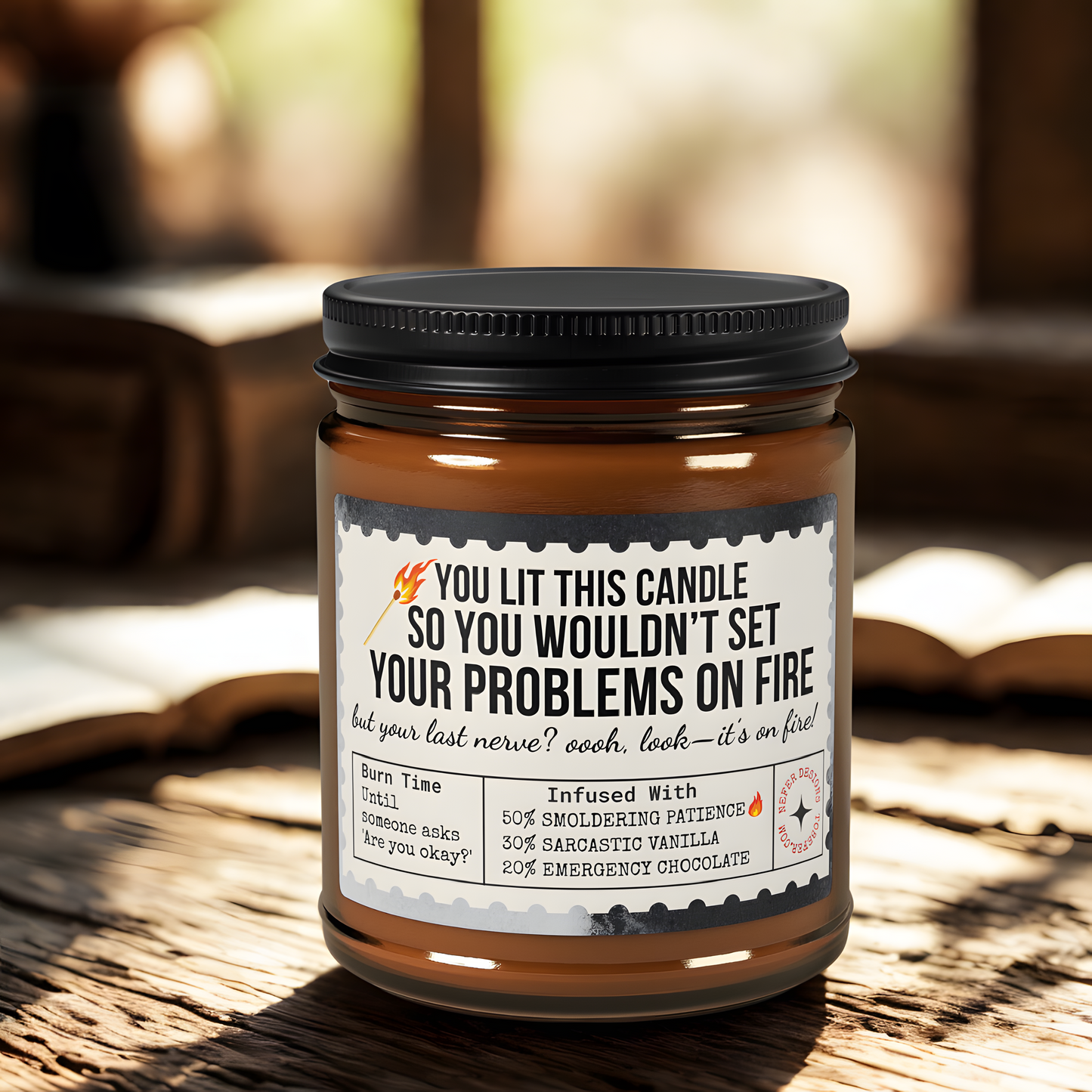 Amber glass 'Last Nerve' candle burning on wooden table, sarcastic label visible ('YOU LIT THIS CANDLE SO YOU WOULDN’T SET YOUR PROBLEMS ON FIRE')