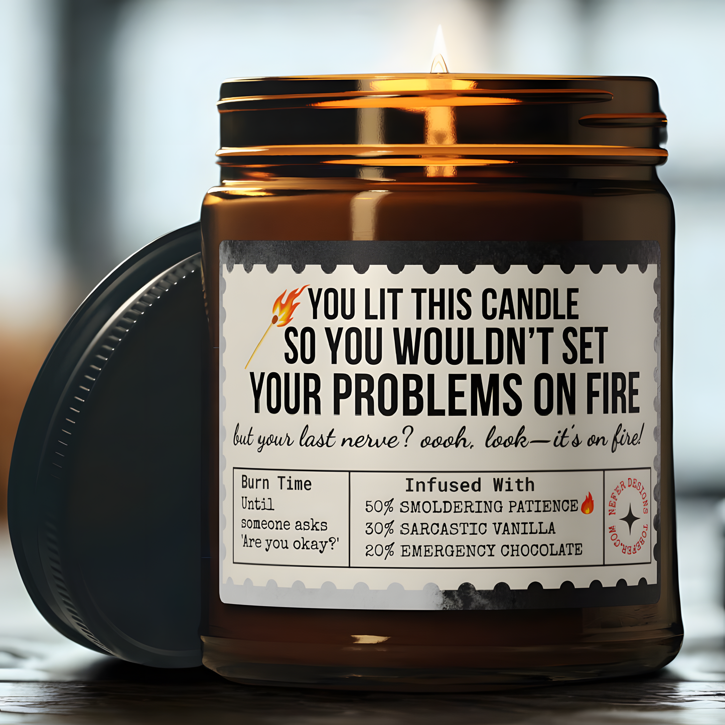 Amber glass 'Last Nerve' candle burning on wooden table, sarcastic label visible ('YOU LIT THIS CANDLE SO YOU WOULDN’T SET YOUR PROBLEMS ON FIRE')
