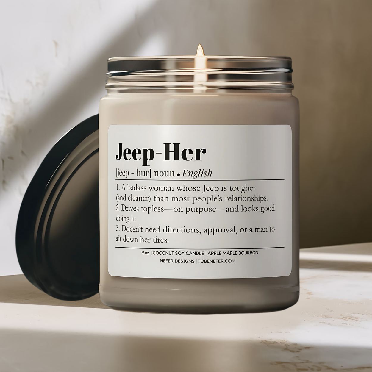 Ecofriendly Candle with Fun Jeep-Her dictionary definition label burning with a clean cotton wick on the marble surface with a neutral background.