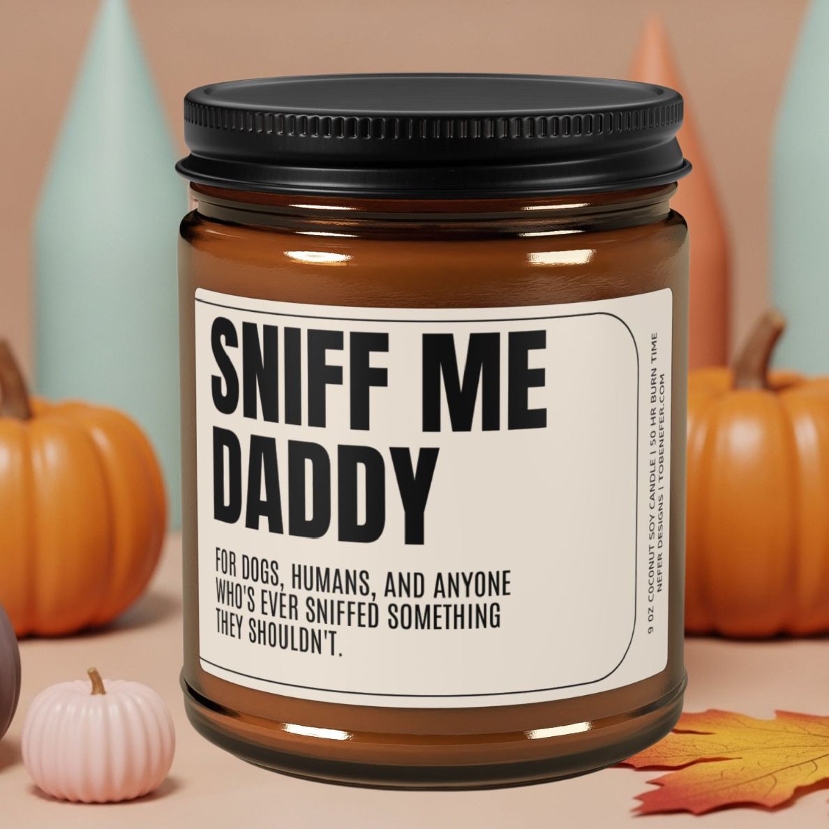 Sniff Me Daddy funny gag gift candle on a pink pedestal against a clean, modern background