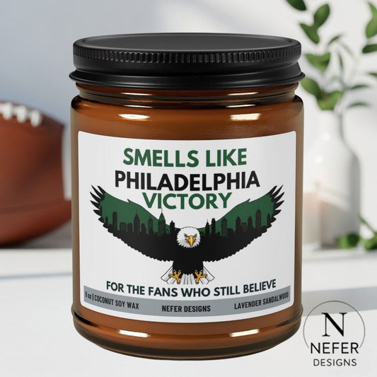Candle jar with label featuring an eagle and text, on a neutral background