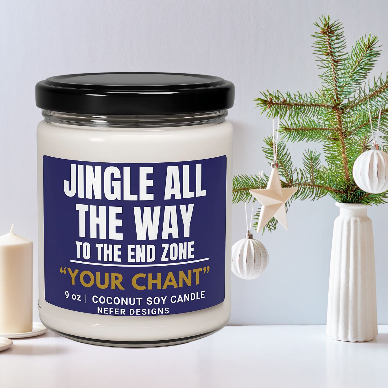 Candle jar with 'Jingle All The Way' label next to Christmas decorations