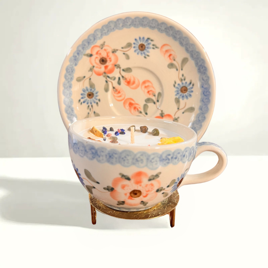 Bolesławiec Polish pottery teacup and saucer featuring a pink and blue floral pattern, handcrafted in 1998 using traditional sponge-stamping techniques