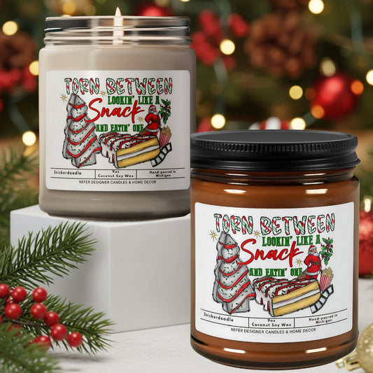 Two candles with festive labels in front of a decorated Christmas tree.