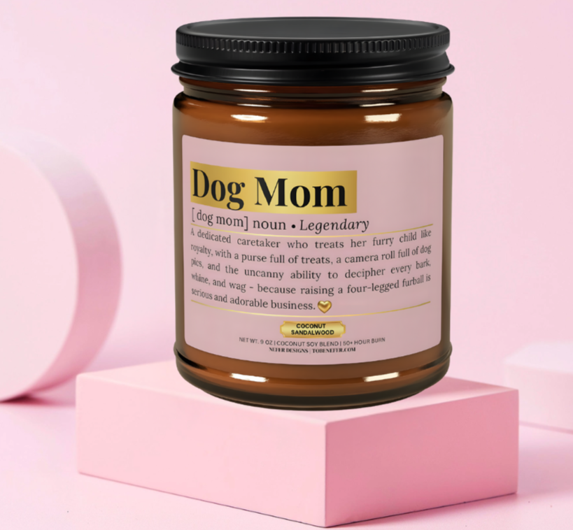 "Dog Mom Dictionary Definition Candle - A humorous soy candle label describing a dog mom as a 'legendary' human who lives for belly rubs, wagging tails, and chaotic walks. Coconut sandalwood scent in amber jar.
