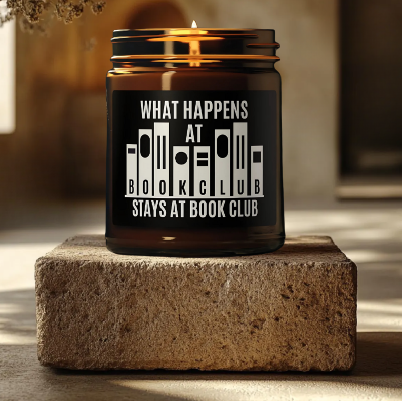 What Happens at Book Club’ candle with graphic novel-style text - perfect gift for rebellious readers.