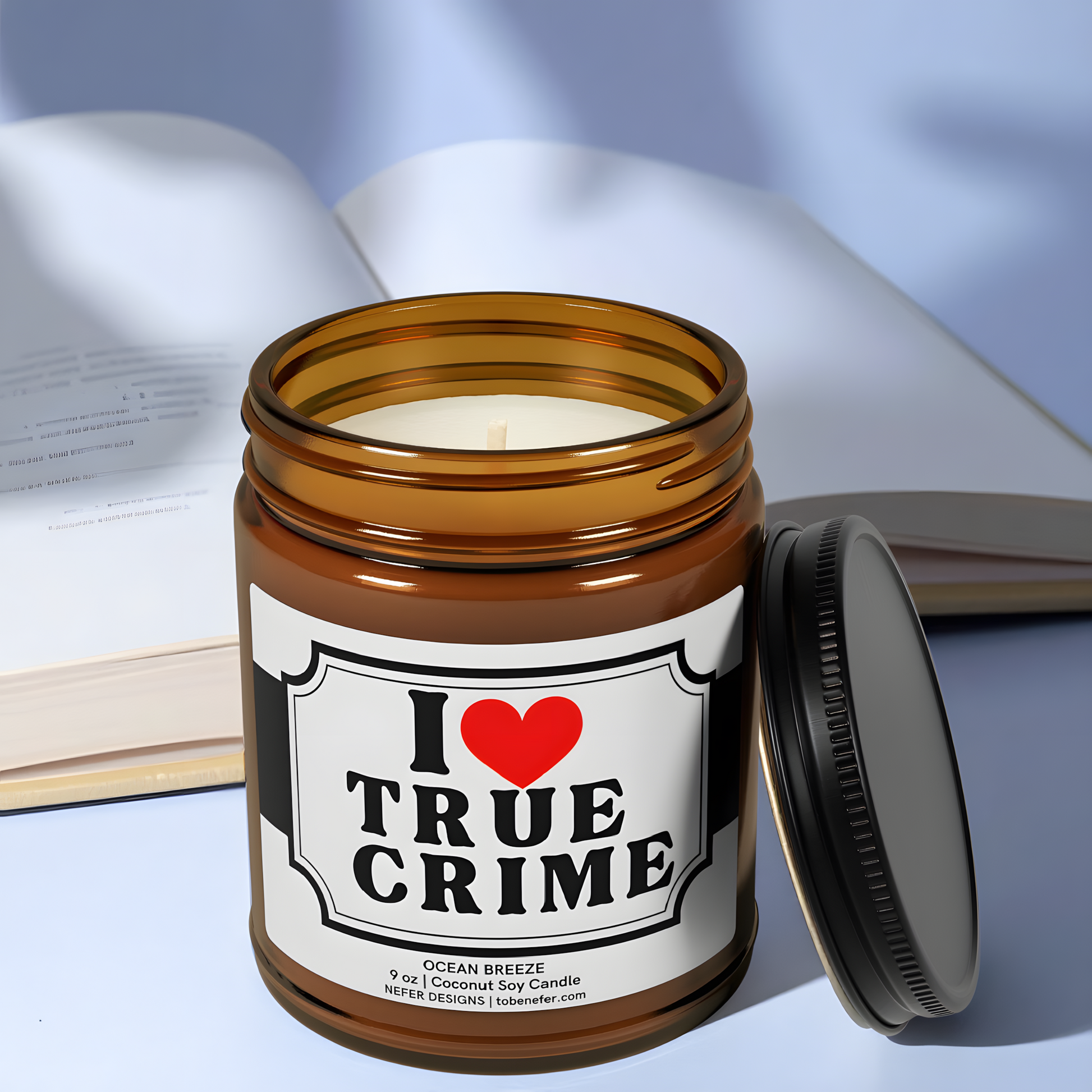 9 oz amber jar candle labeled with true crime book theme, surrounded by red string, evidence tags, and paperback thrillers.