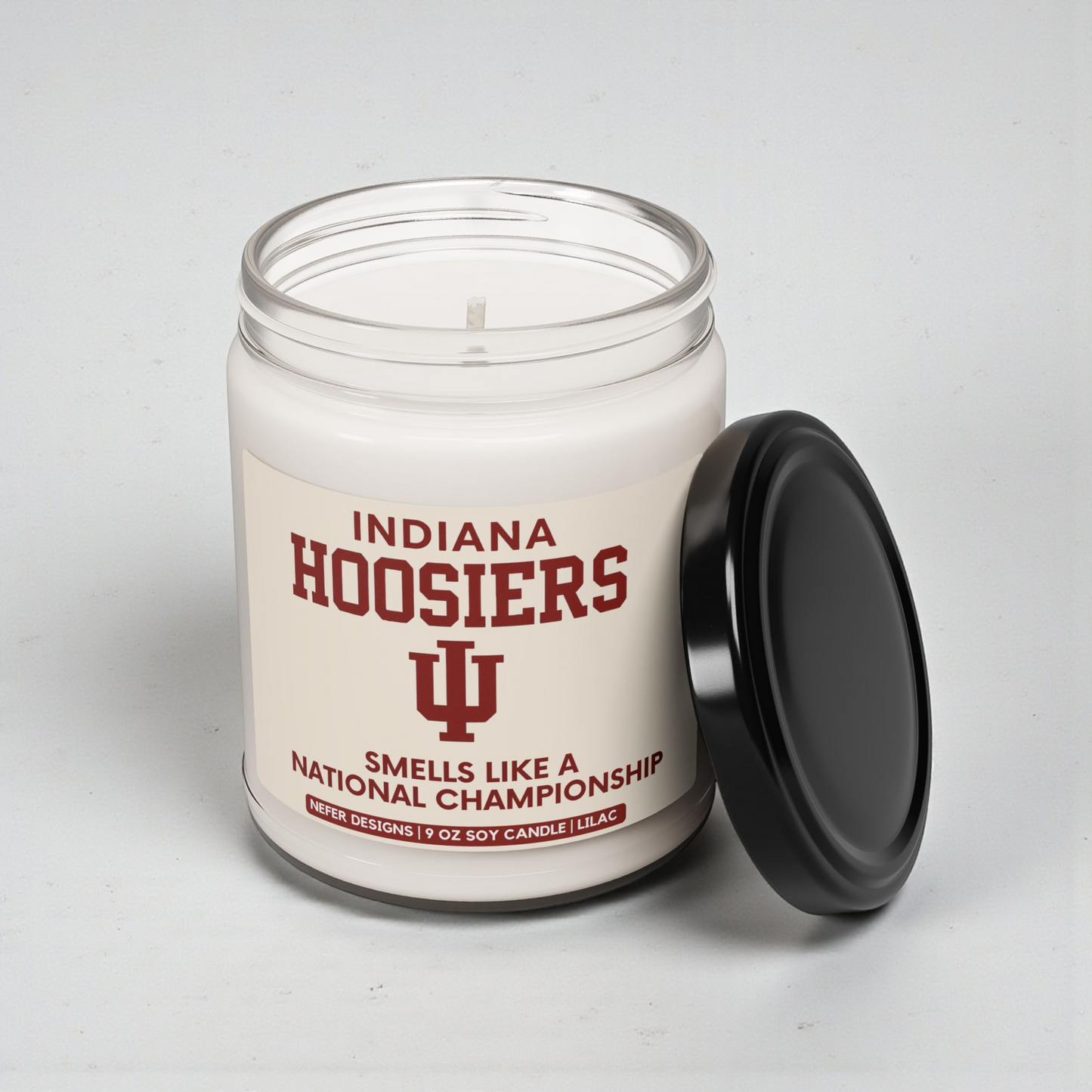 Candle in a glass jar with 'Indiana Hoosiers' text and logo on a white background