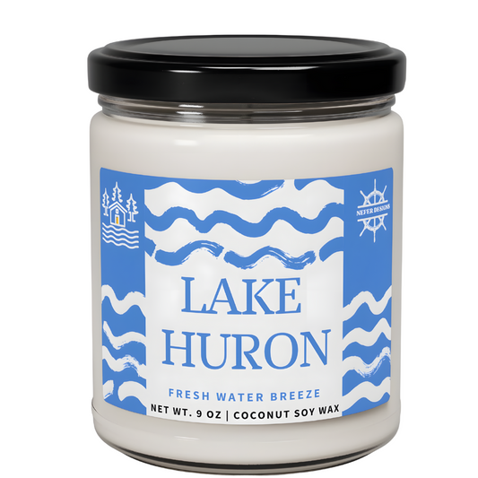 A candle labeled 'LAKE HURON' with 'FRESH WATER BREEZE' scent, made from coconut soy wax, net weight 9 ounces. The design features a clean, minimalist style with bold text on a neutral background