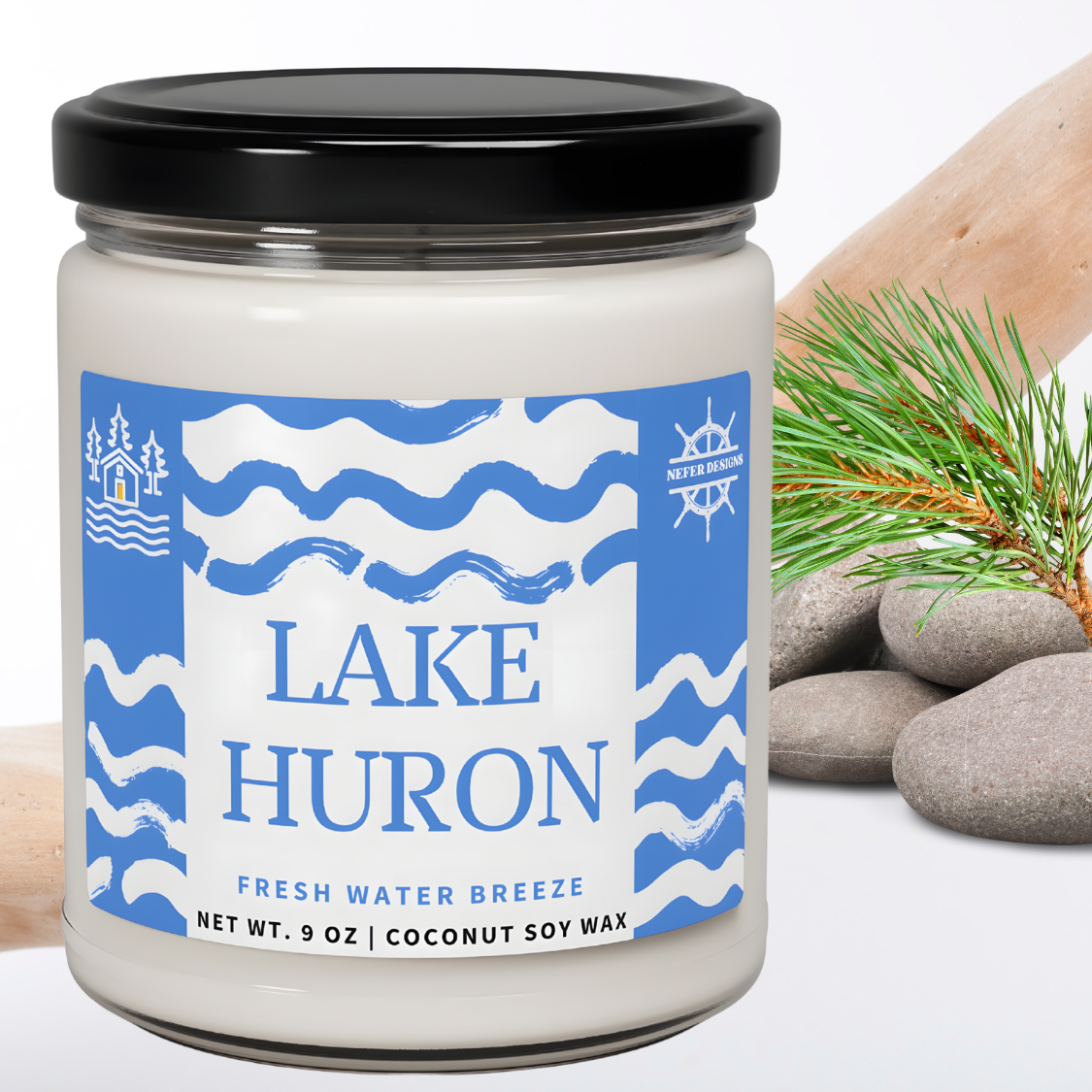 White candle with 'LAKE HURON' and 'FRESH WATER BREEZE' printed in elegant typography, highlighting its fresh water-inspired fragrance and 9-ounce coconut soy wax composition.