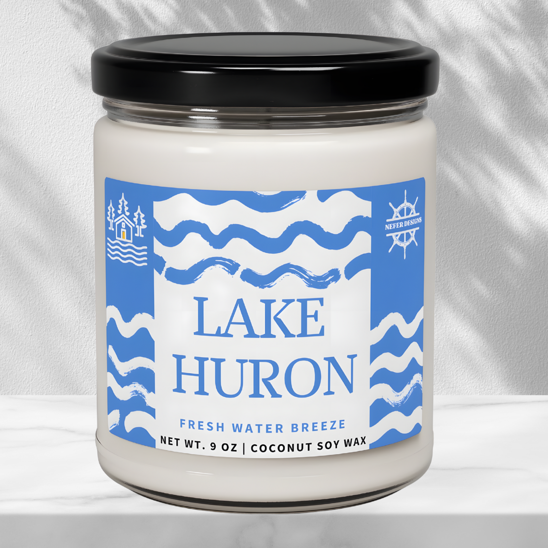 "Sleek, modern candle packaging showcasing 'LAKE HURON' and its 'FRESH WATER BREEZE' scent, with clear labeling of the 9-ounce net weight and eco-friendly coconut soy wax.