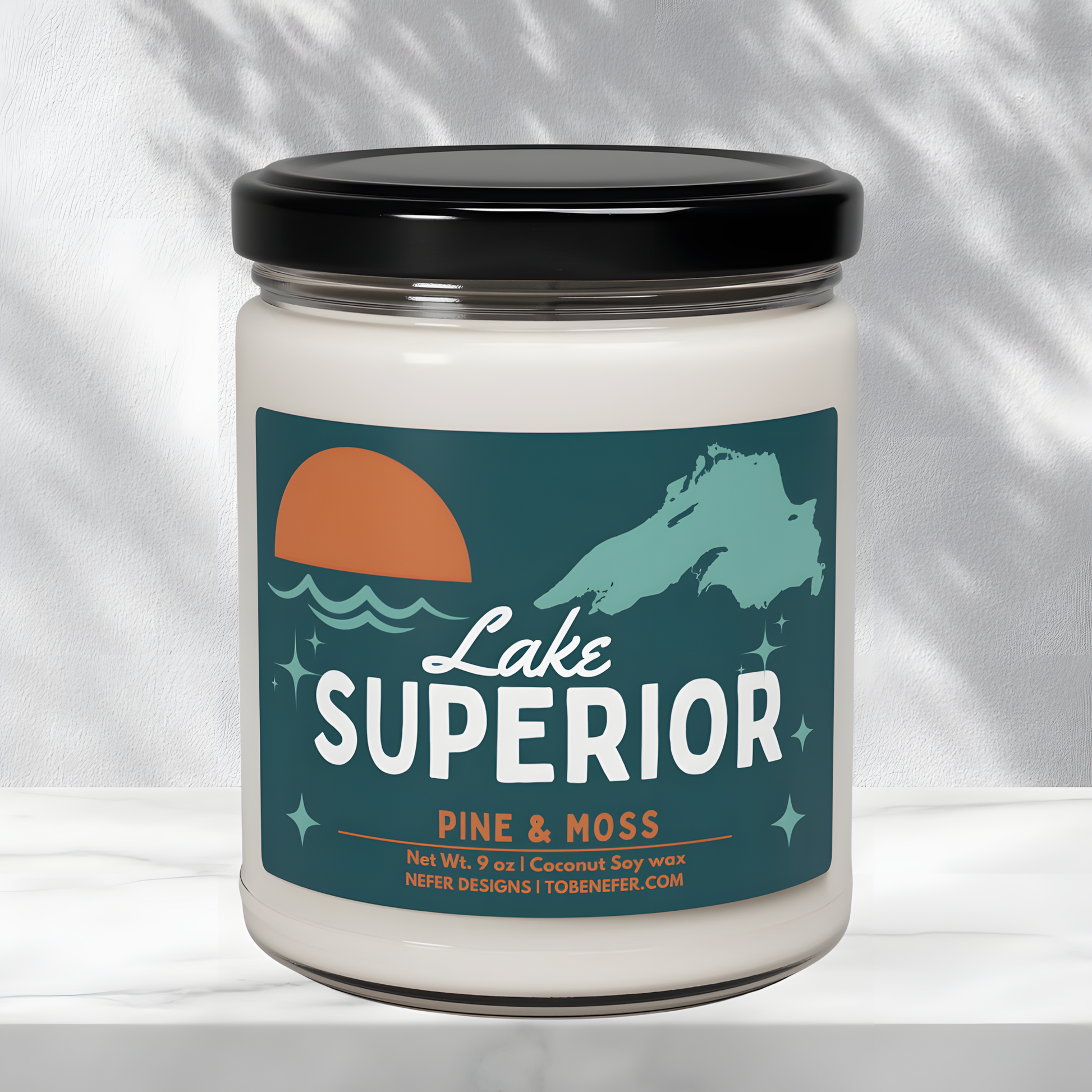 Alternative angle of the 'Lake Superior' candle showing the full label with 'Pine & Moss' fragrance details, 9 oz net weight