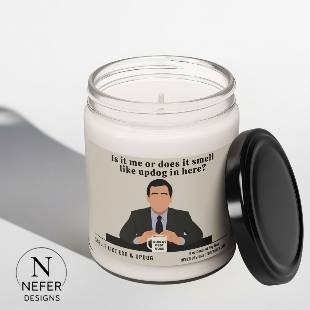 The office show themed candle with the label showing micheal scott by saying is it me or does it smell like updog in here?