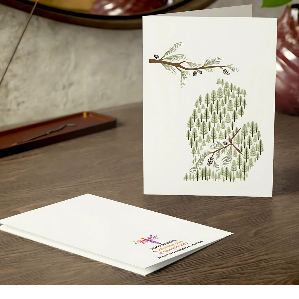 Greeting card with nature-themed design on a wooden surface