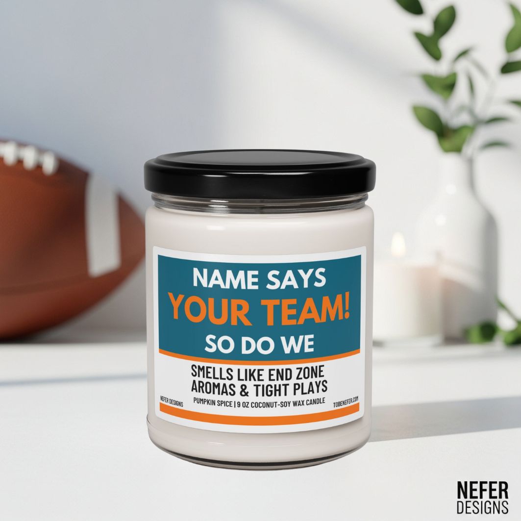 Candle jar with a customizable team name label on a white surface with sports-themed decor.
