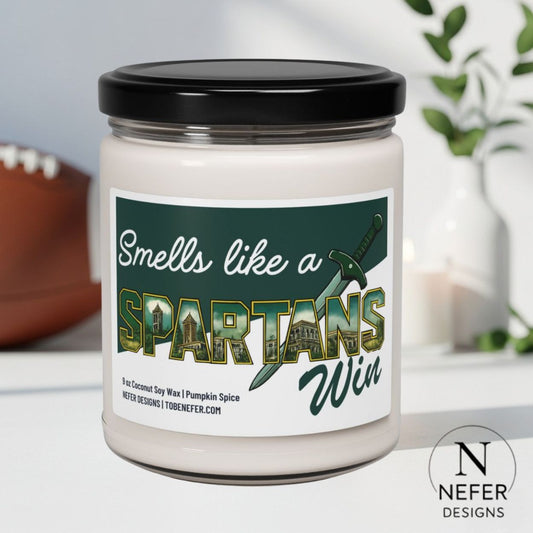 Candle jar with 'Smells like a Spartans Win' label on a neutral background