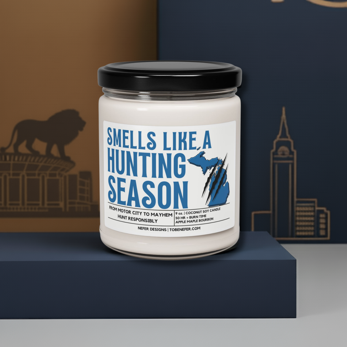 Candle jar with a label reading 'Smells Like a Hunting Season' on a blue platform.