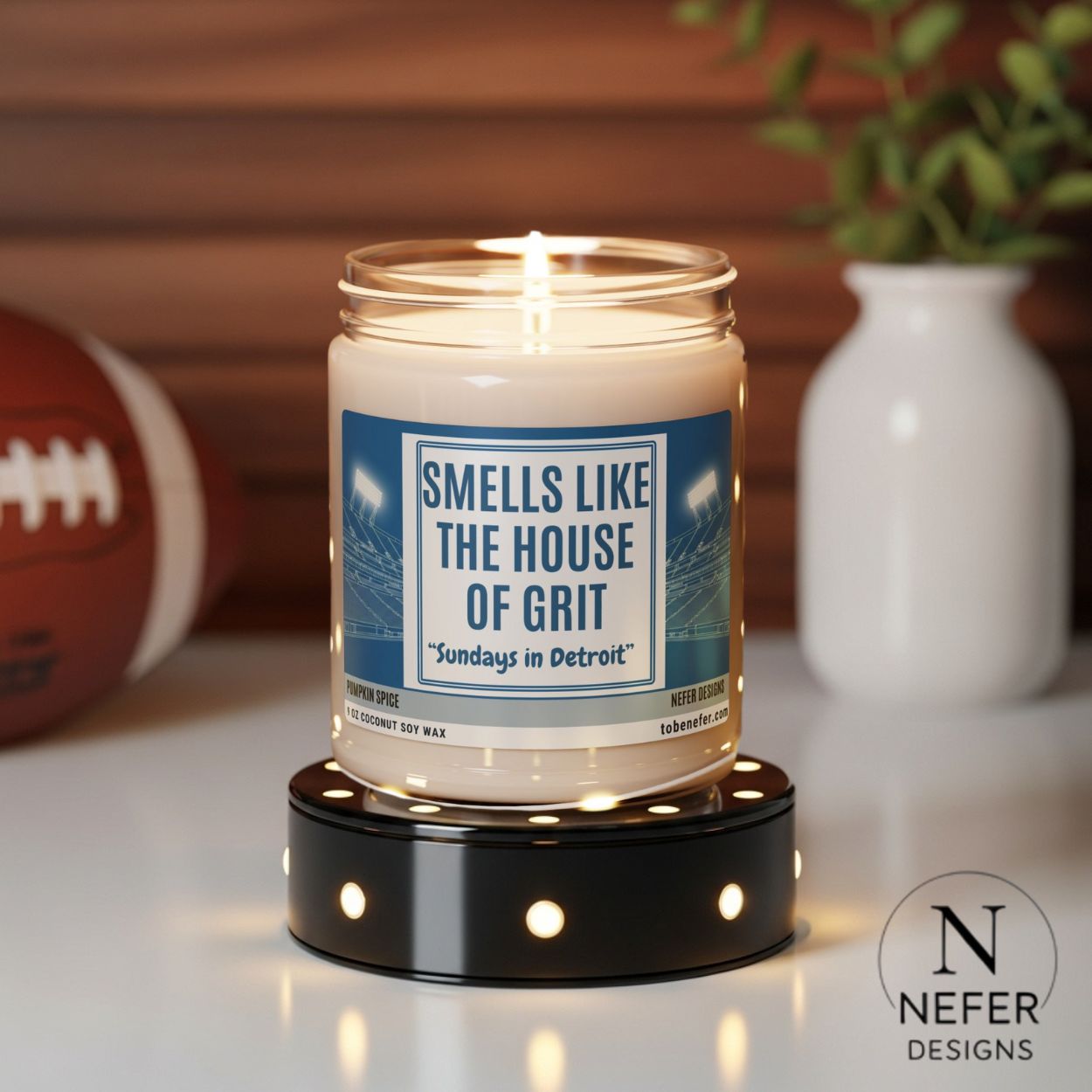 Candle in a jar with a label on a candle holder, surrounded by sports-themed items.
