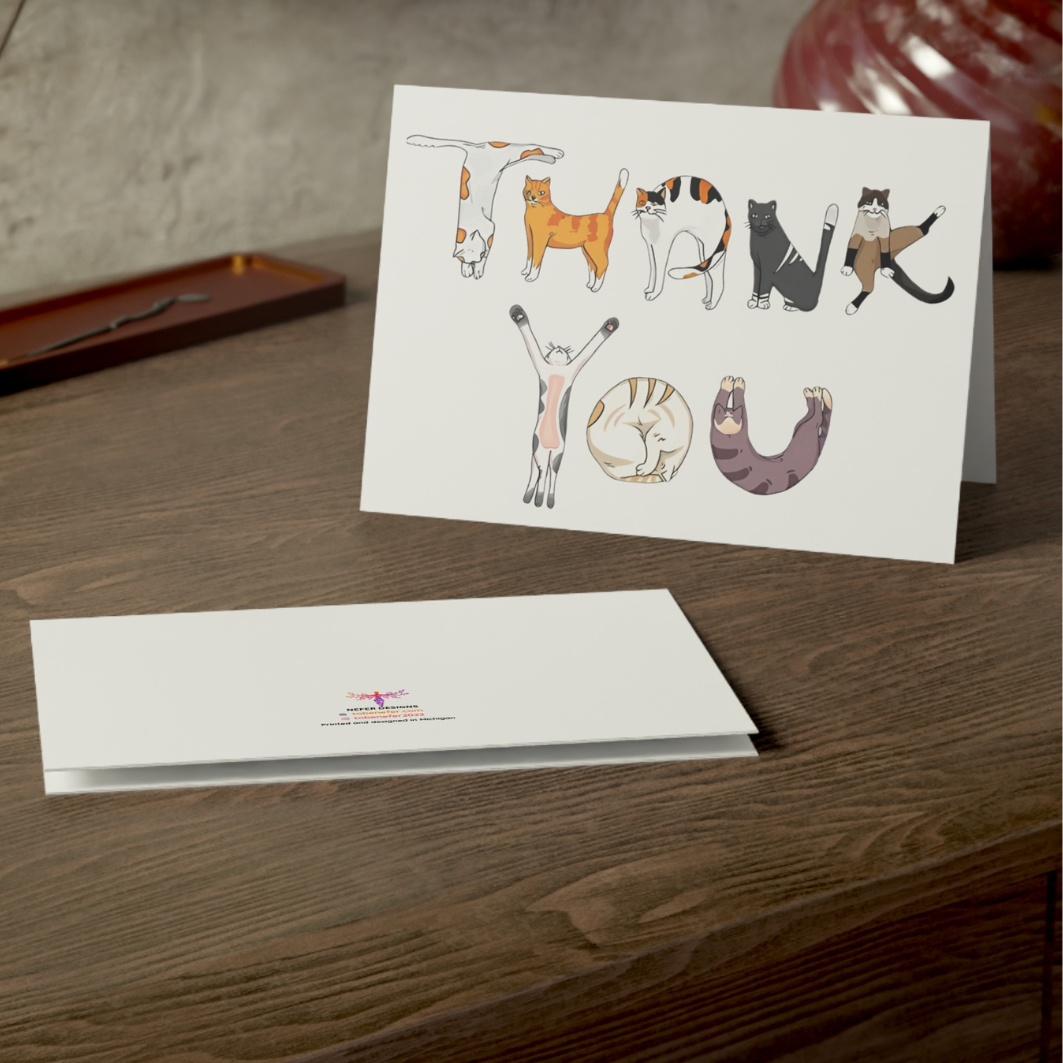 Greeting card with cat illustrations on a wooden surface