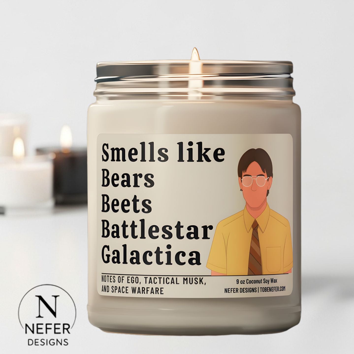 Candle with a label featuring witty text from the Office Sitcom Show and an illustration of Dwight Schrutz face, with 'Nefer Designs' branding.