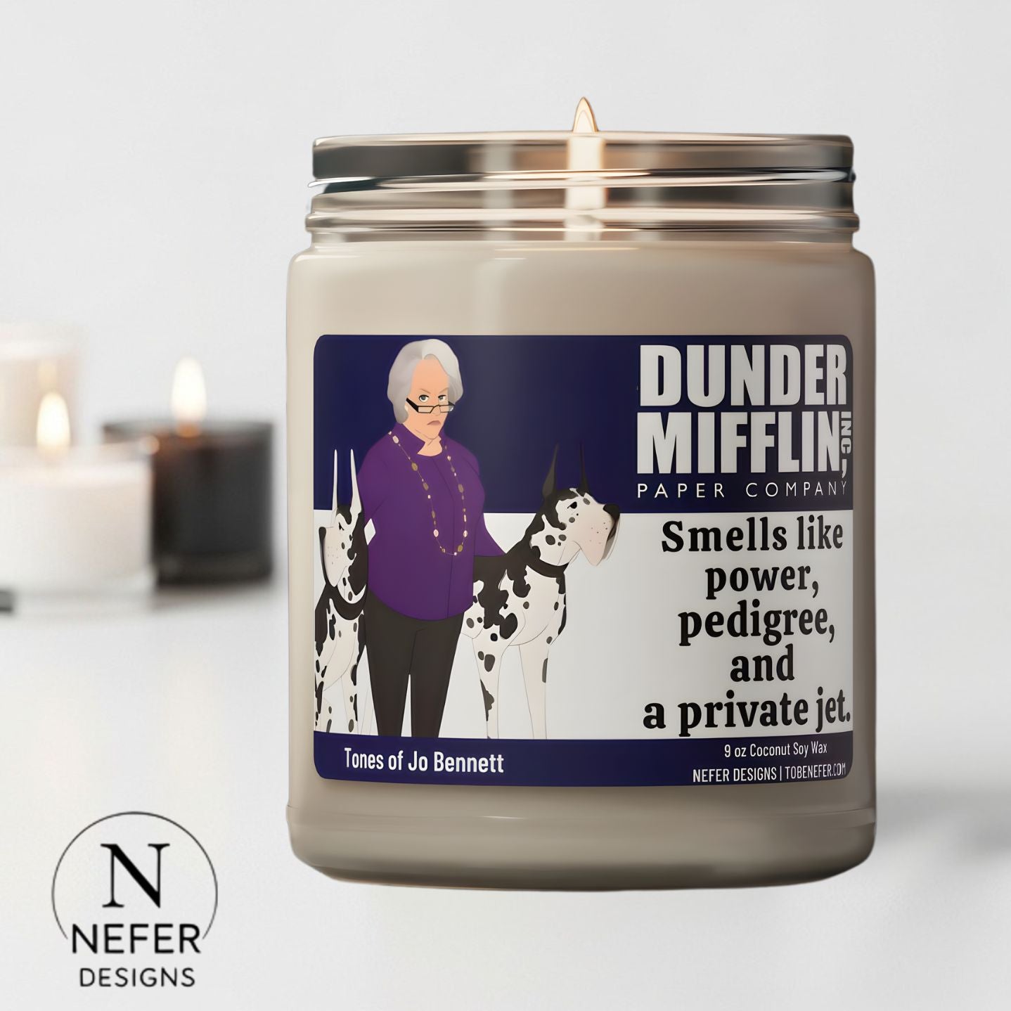 Candle with a label featuring  The Office CEO  Jo Bennett 1and a dog, with 'Dunder Mifflin' branding and text.